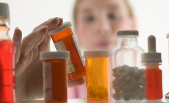 Woman looks at her prescription medication.